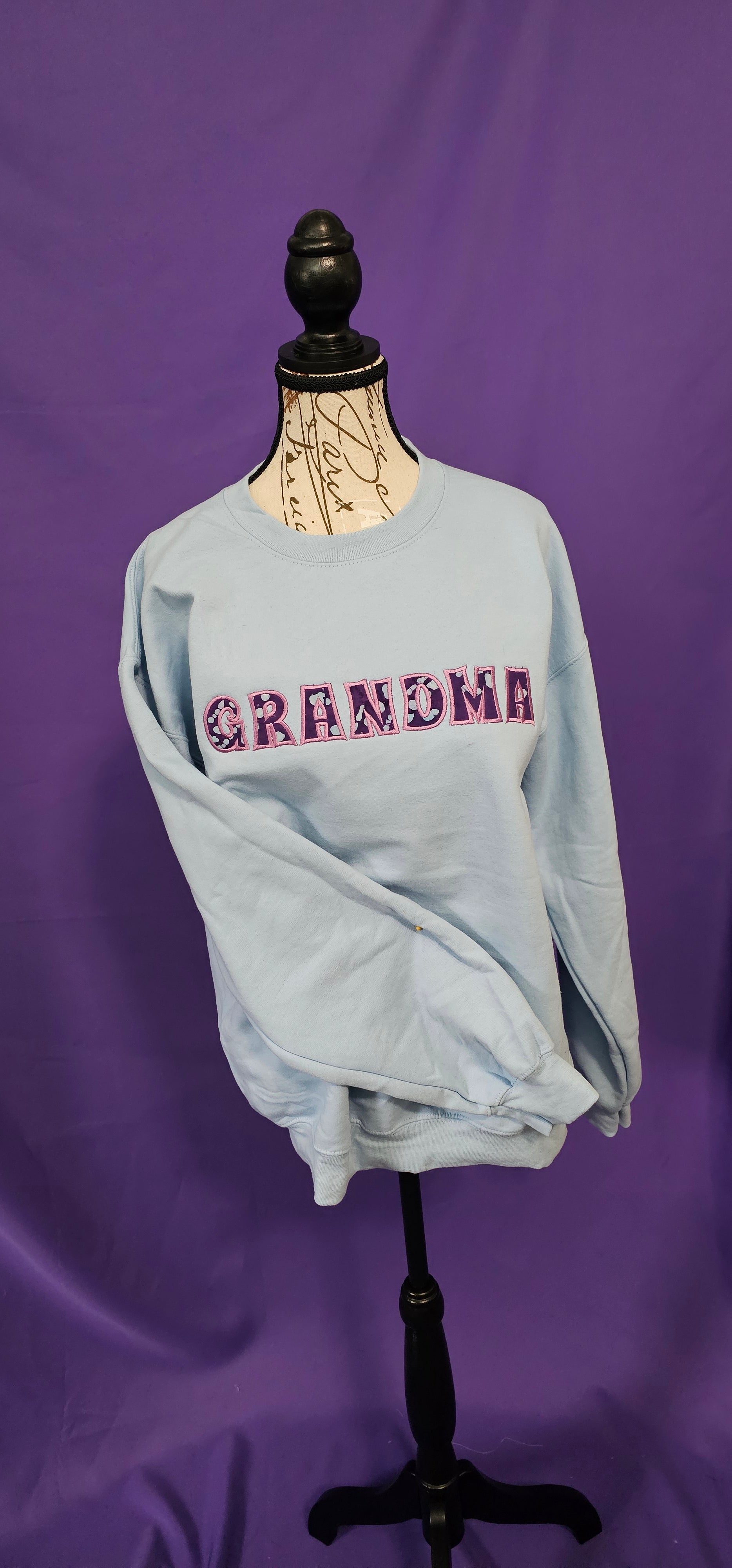 Sweatshirt with a custom Applique saying "Grandma" on it. 