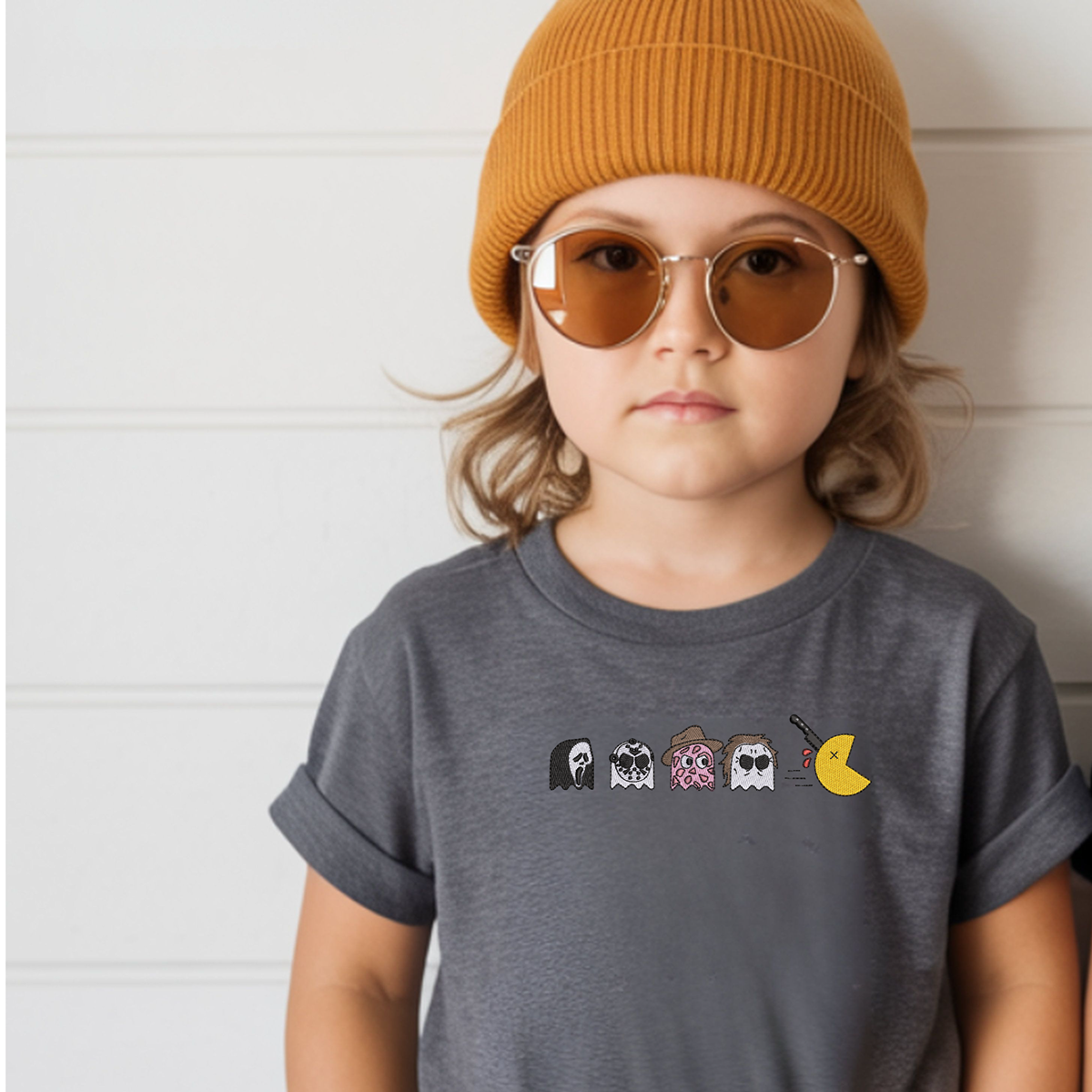Grey childs t shirt with pac man characters embroidered on it